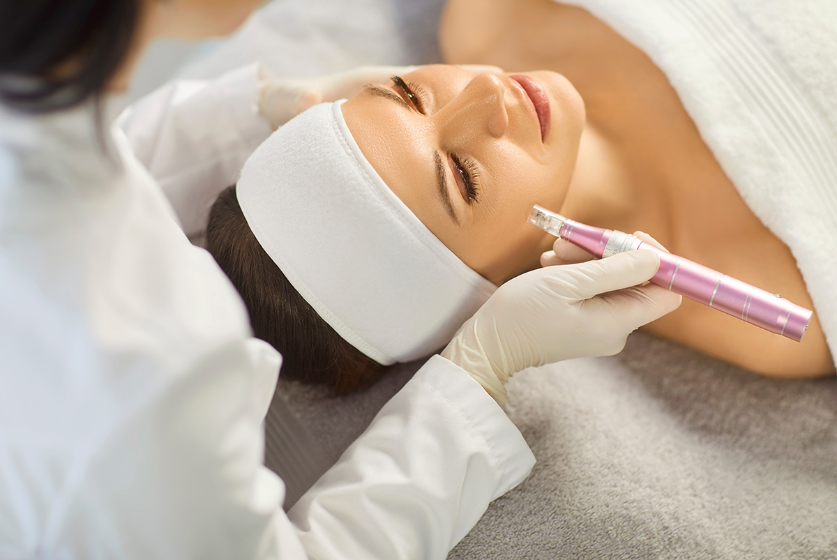 Practitioner doing micro needling procedure.