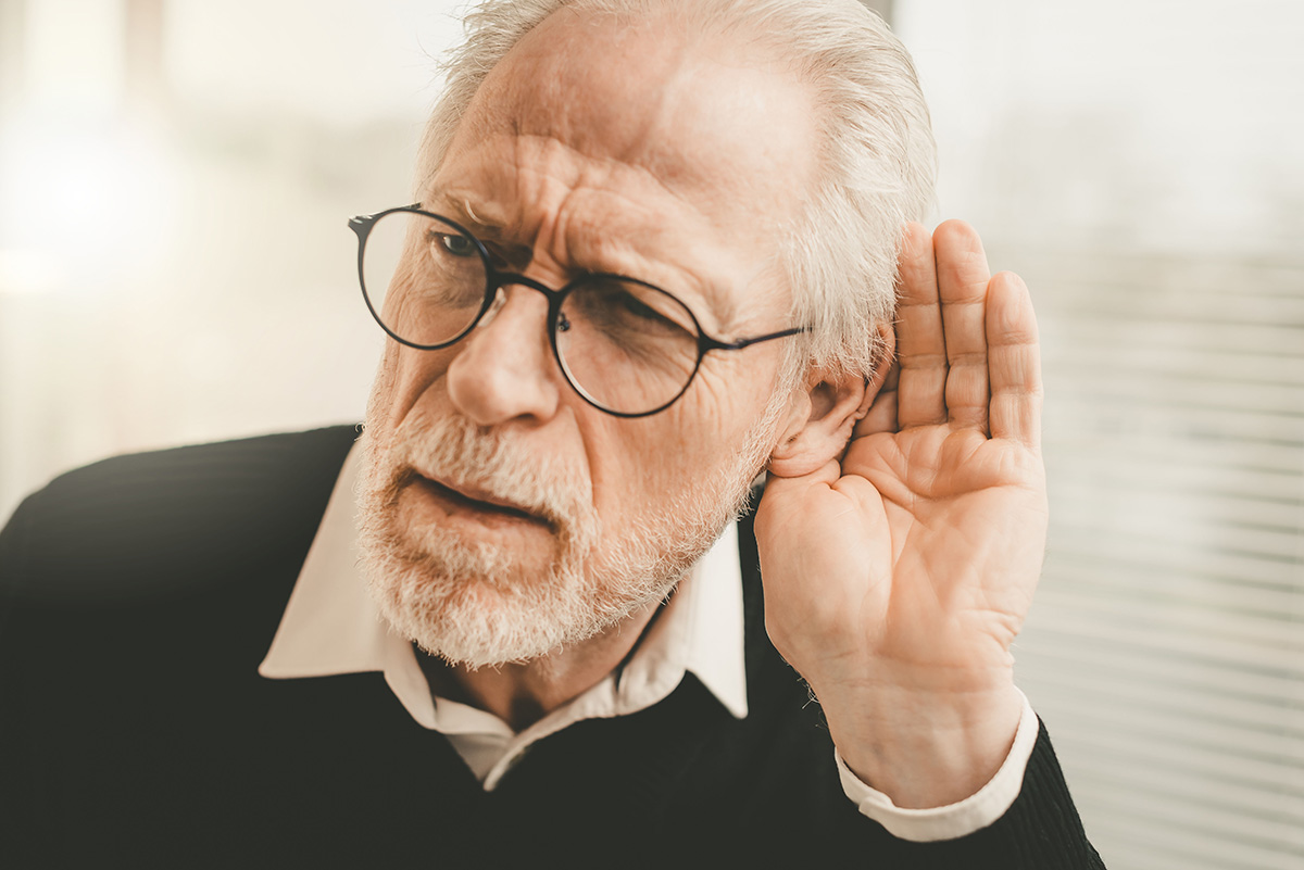 Senior man with hearing problems